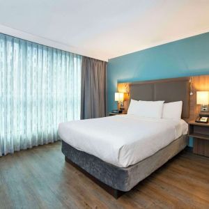 Romantic king room with natural light at Grand Park Hotel & Suites Downtown Vancouver.