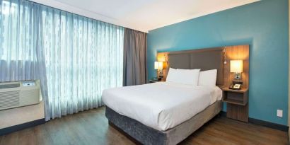 Romantic king room with natural light at Grand Park Hotel & Suites Downtown Vancouver.