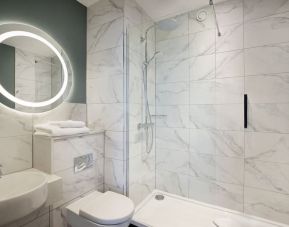 Guest bathroom with shower at Leonardo Royal Hotel Birmingham.