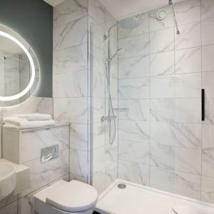 Guest bathroom with shower at Leonardo Royal Hotel Birmingham.