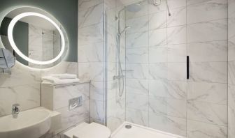 Guest bathroom with shower at Leonardo Royal Hotel Birmingham.