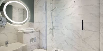 Guest bathroom with shower at Leonardo Royal Hotel Birmingham.