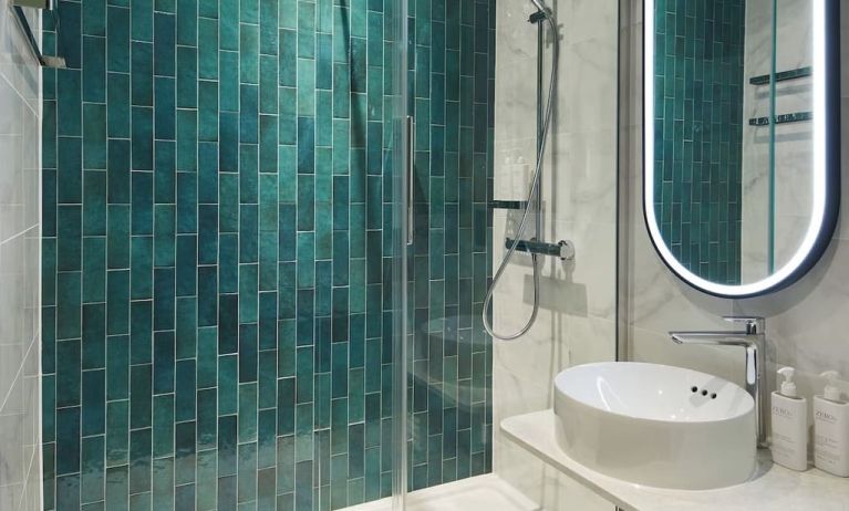 Guest bathroom with shower at Leonardo Royal Hotel Glasgow.