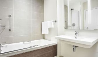 Guest bathroom with shower and tub at Leonardo Hotel And Conference Venue Hinckley Island.