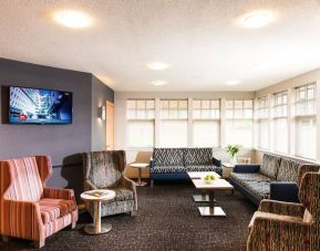 Lobby and coworking lounge at Leonardo Inn Aberdeen Airport.
