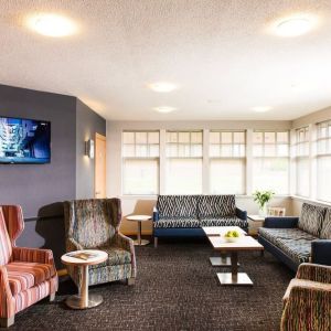 Lobby and coworking lounge at Leonardo Inn Aberdeen Airport.
