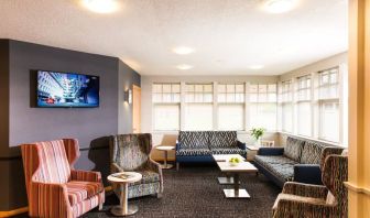 Lobby and coworking lounge at Leonardo Inn Aberdeen Airport.
