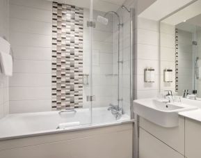 Guest bathroom with shower and tub at Leonardo Hotel Chester.