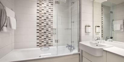 Guest bathroom with shower and tub at Leonardo Hotel Chester.