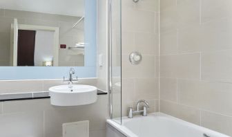 Guest bathroom with shower and tub at Leonardo Hotel Edinburgh City.