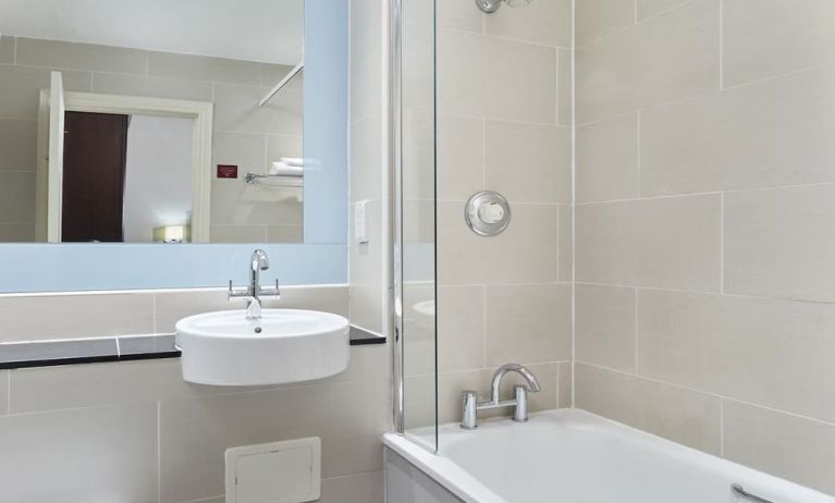 Guest bathroom with shower and tub at Leonardo Hotel Edinburgh City.