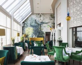 Modern dining area with high ceiling and natural light at The Grand Brighton.