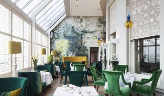 Modern dining area with high ceiling and natural light at The Grand Brighton.