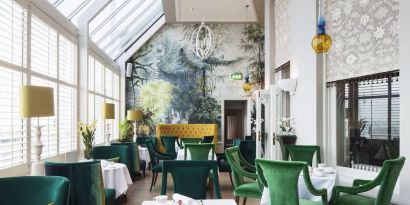 Modern dining area with high ceiling and natural light at The Grand Brighton.