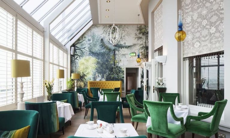 Modern dining area with high ceiling and natural light at The Grand Brighton.