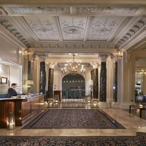 Reception area with elegant architectural details and decorative chandeliers at The Grand Brighton. 