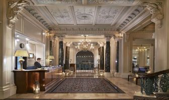 Reception area with elegant architectural details and decorative chandeliers at The Grand Brighton. 