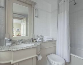 Guest bathroom with shower and tub at The Grand Brighton. 