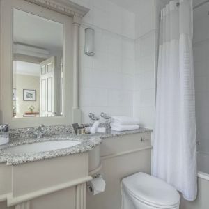 Guest bathroom with shower and tub at The Grand Brighton. 