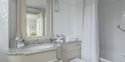 Guest bathroom with shower and tub at The Grand Brighton. 