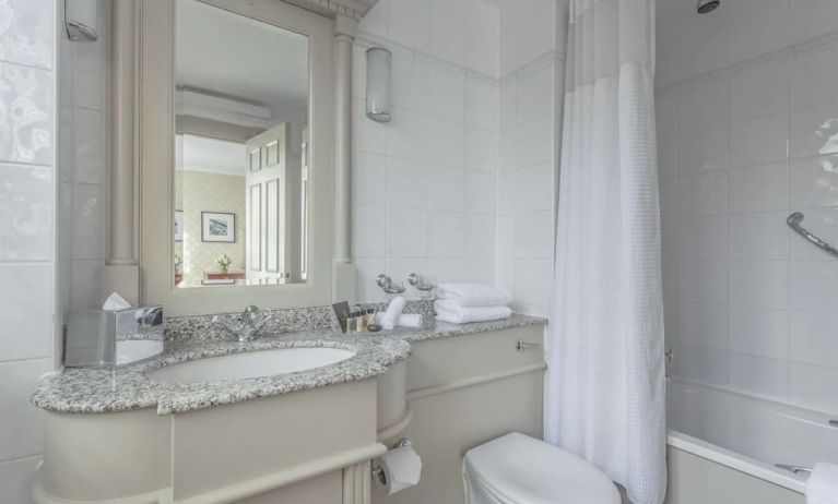 Guest bathroom with shower and tub at The Grand Brighton. 