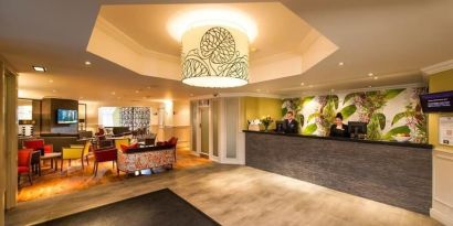 Reception and coworking lounge at Leonardo Inn Glasgow West End. 