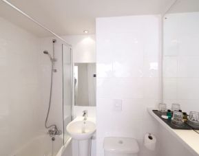 Guest bathroom with shower at Leonardo Inn Glasgow West End. 