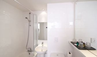 Guest bathroom with shower at Leonardo Inn Glasgow West End. 