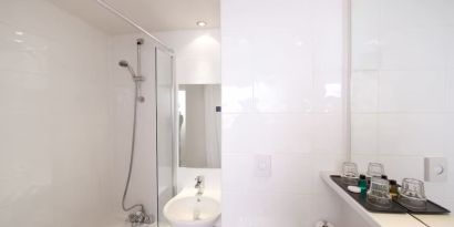 Guest bathroom with shower at Leonardo Inn Glasgow West End. 