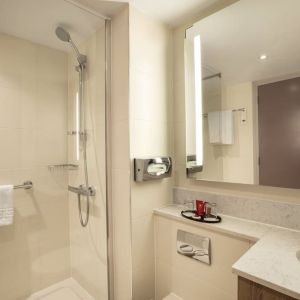 Guest bathroom with shower at Leonardo Hotel London Heathrow Airport.