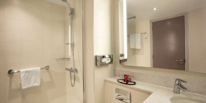 Guest bathroom with shower at Leonardo Hotel London Heathrow Airport.