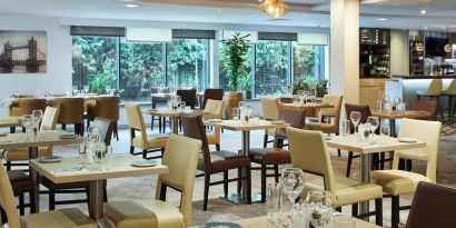 Dining area perfect for coworking at Leonardo Hotel London Heathrow Airport.