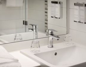 Guest bathroom with shower at Leonardo Hotel Manchester Piccadilly. 