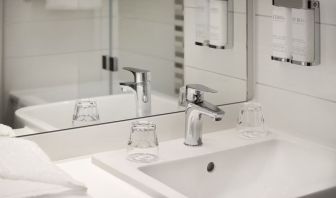 Guest bathroom with shower at Leonardo Hotel Manchester Piccadilly. 