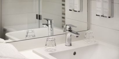 Guest bathroom with shower at Leonardo Hotel Manchester Piccadilly. 