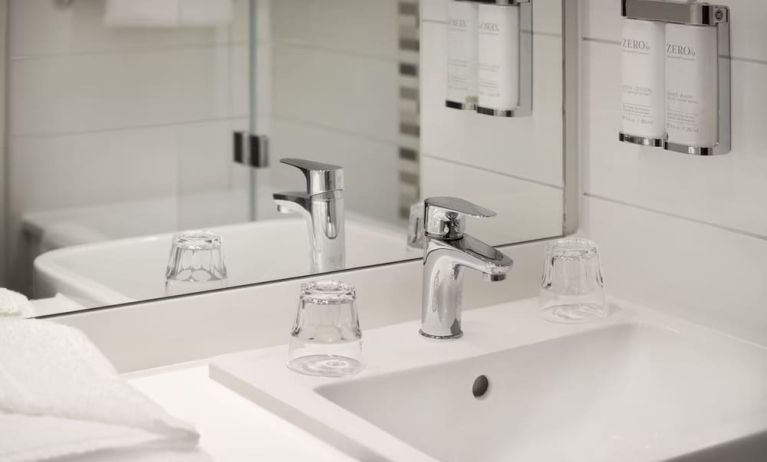 Guest bathroom with shower at Leonardo Hotel Manchester Piccadilly. 