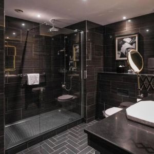 Guest bathroom with shower at Hotel Gotham.  