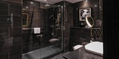 Guest bathroom with shower at Hotel Gotham.  