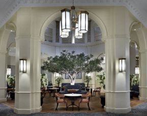 Bright lobby with arches and greeneries at The Midland - A Leonardo Royal Hotel.  