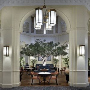 Bright lobby with arches and greeneries at The Midland - A Leonardo Royal Hotel.  