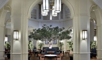 Bright lobby with arches and greeneries at The Midland - A Leonardo Royal Hotel.  