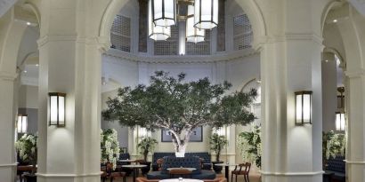 Bright lobby with arches and greeneries at The Midland - A Leonardo Royal Hotel.  