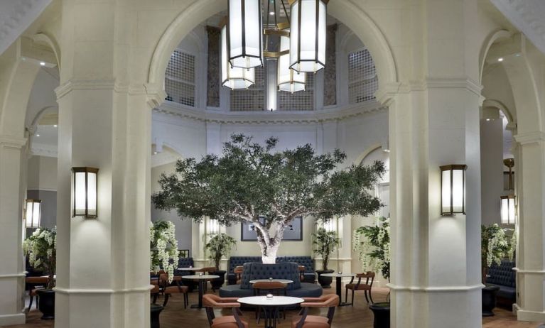 Bright lobby with arches and greeneries at The Midland - A Leonardo Royal Hotel.  