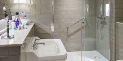 Guest bathroom with shower at The Midland - A Leonardo Royal Hotel.