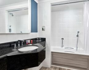 Guest bathroom with shower and tub at Leonardo Hotel Southampton Grand Harbour.