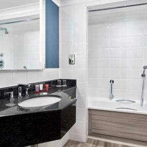 Guest bathroom with shower and tub at Leonardo Hotel Southampton Grand Harbour.