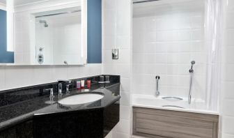 Guest bathroom with shower and tub at Leonardo Hotel Southampton Grand Harbour.