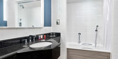 Guest bathroom with shower and tub at Leonardo Hotel Southampton Grand Harbour.