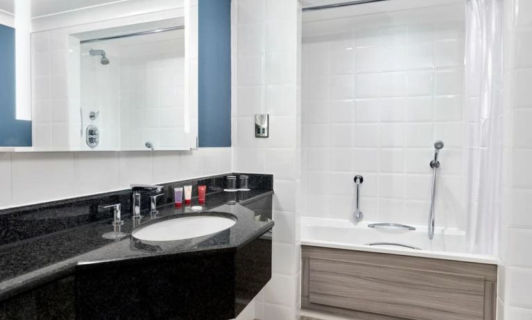 Guest bathroom with shower and tub at Leonardo Hotel Southampton Grand Harbour.