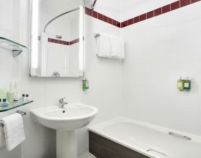 Guest bathroom with shower and tub at Leonardo Hotel Liverpool.